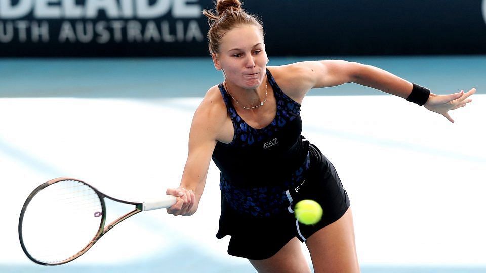 Veronika Kudermetova attempts to retrieve a ball